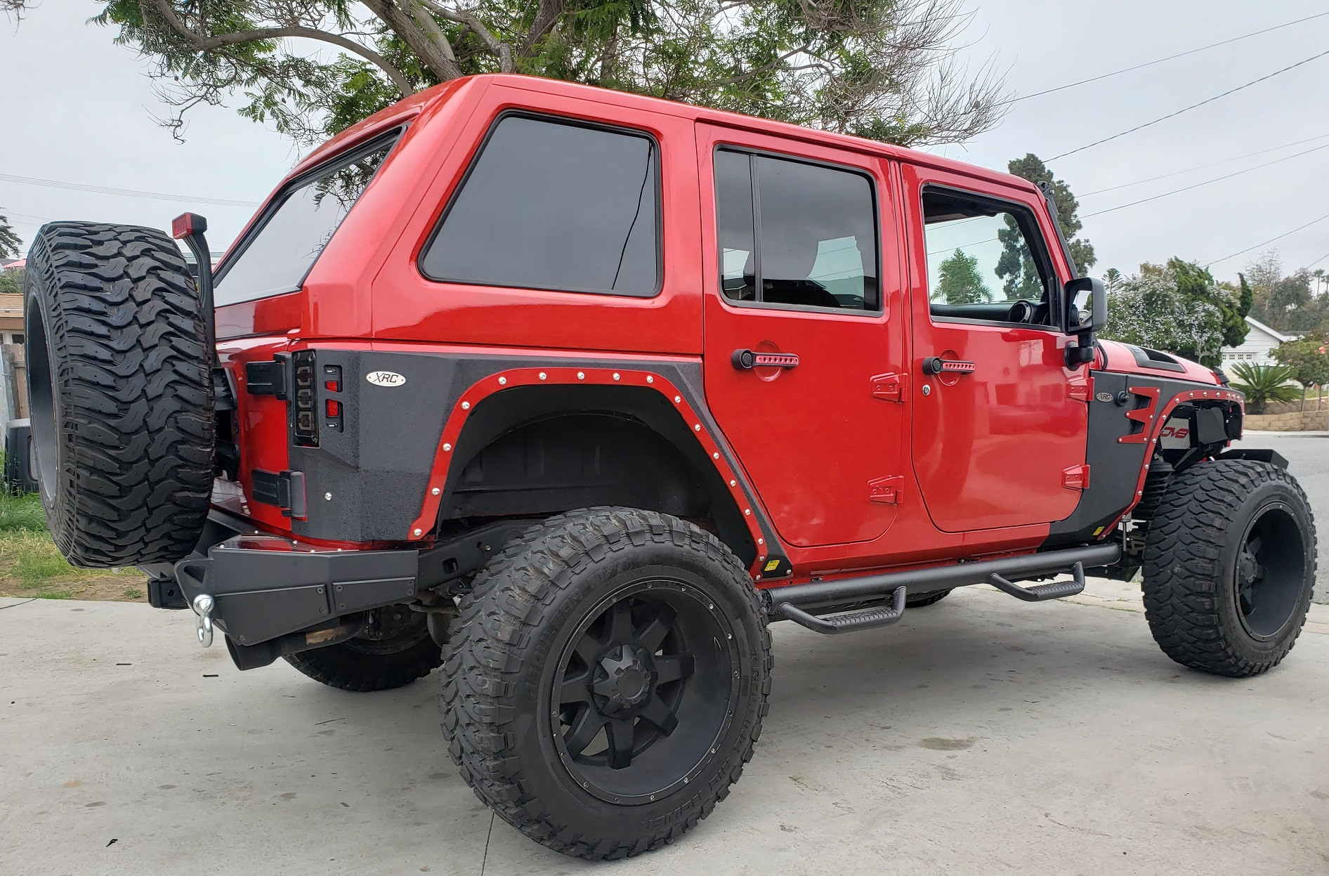Red Jeep Wrangler JKU with black fastback hard top installed