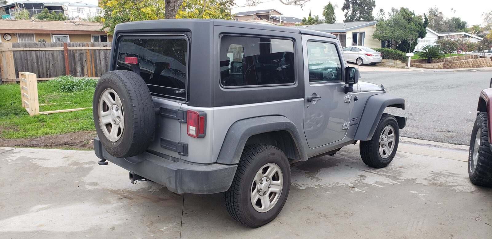 Silver Jeep Wrangler JK 2 Door with black hard top installed