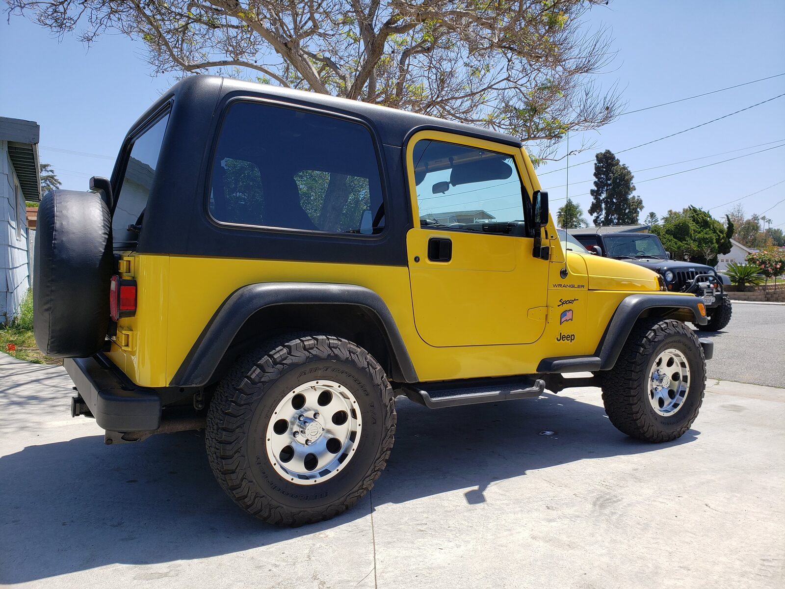 Yellow Jeep Wrangler TJ with black hard top installed