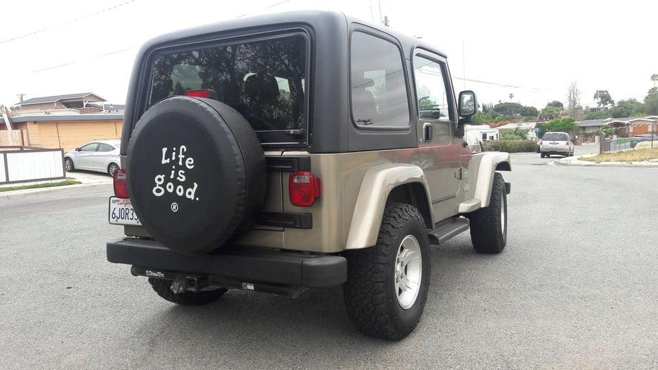 Gray Jeep Wrangler TJ with Camper King USA hard top installed