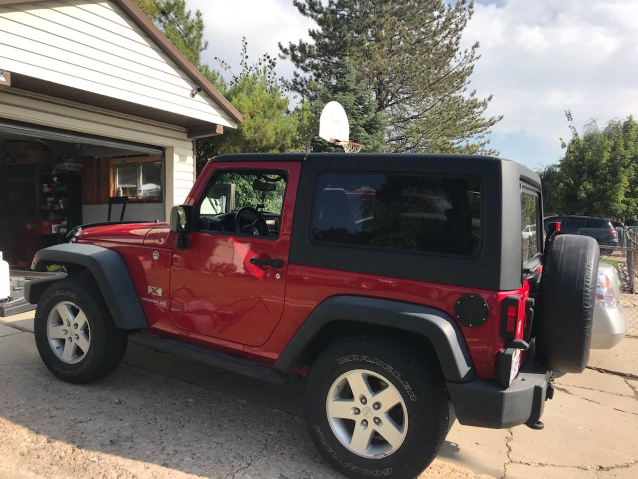 Red Jeep Wrangler JK 2 Door with black hard top installed