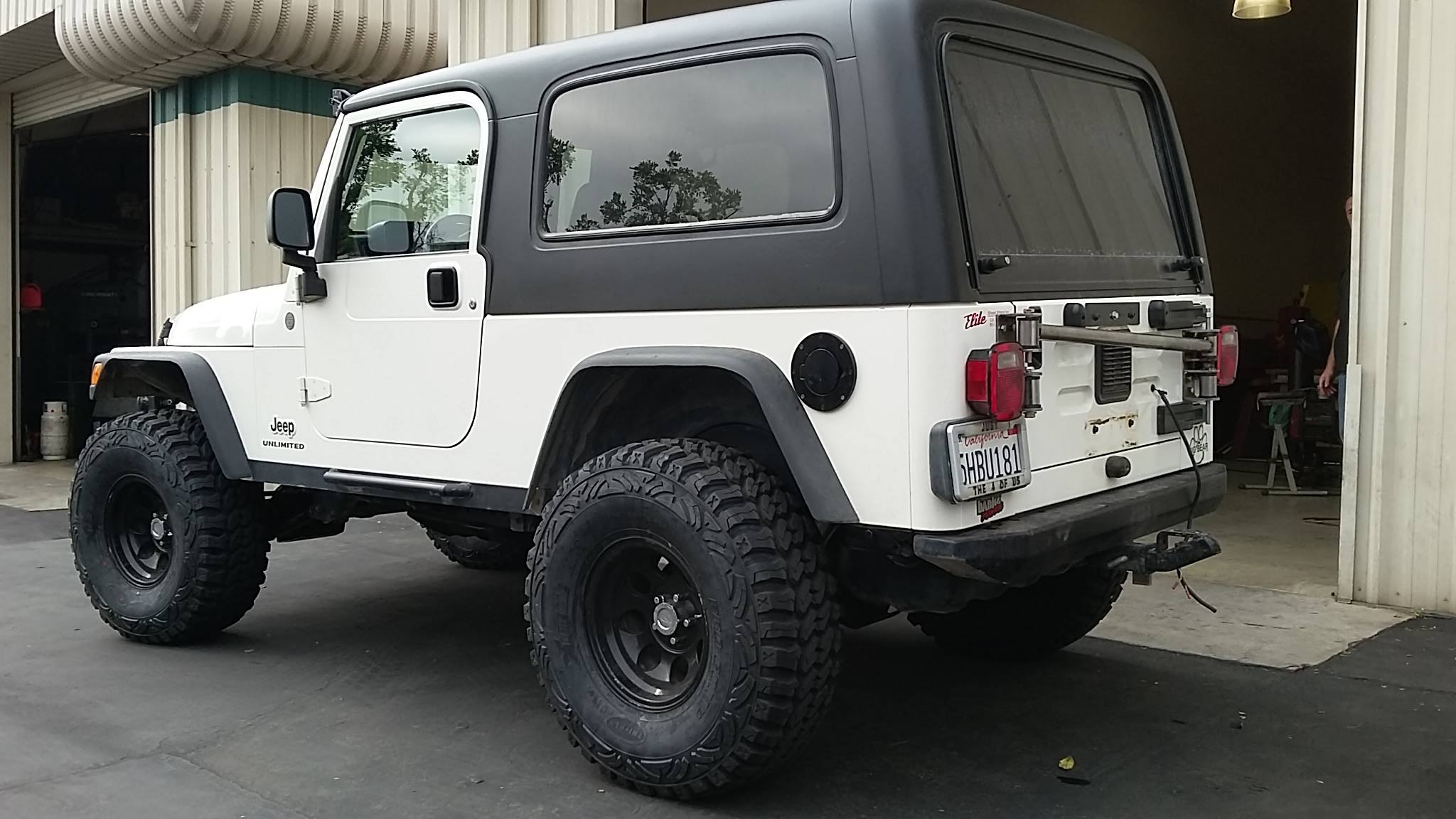 White Jeep Wrangler LJ Unlimited with black hard top installed