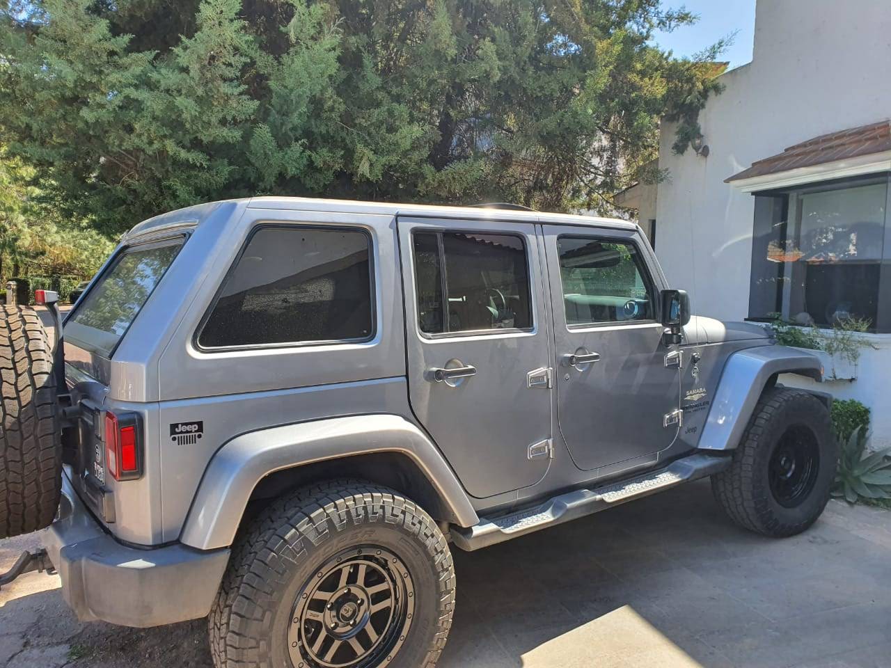 Silver Jeep Wrangler JKU with fastback hard top installed