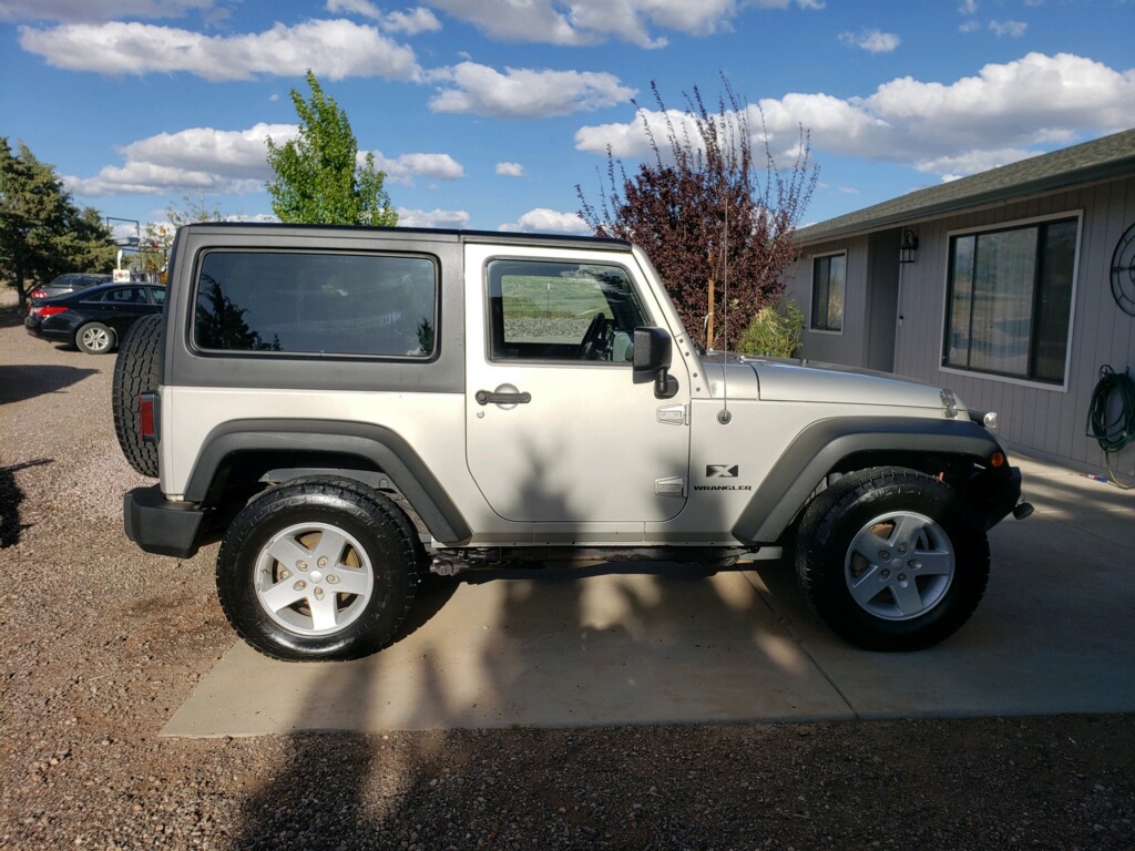 Silver Jeep Wrangler JK 2 Door with black Camper King USA hard top