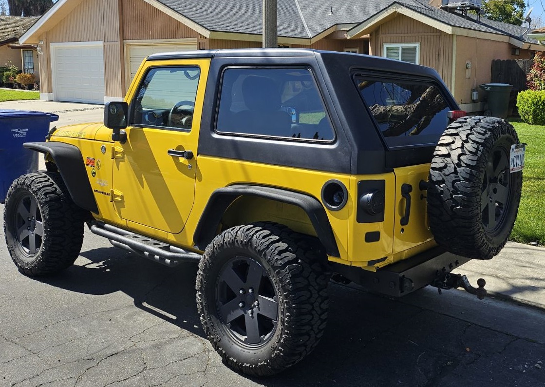 Yellow Jeep Wrangler JK 2 Door with black fastback hard top