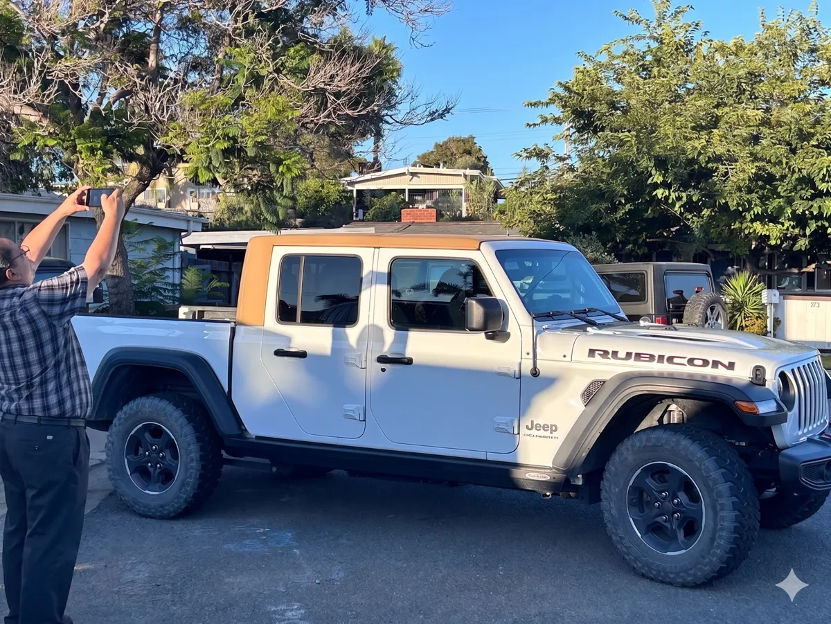 White Jeep Gladiator with tan one-piece Camper King USA hard top installed